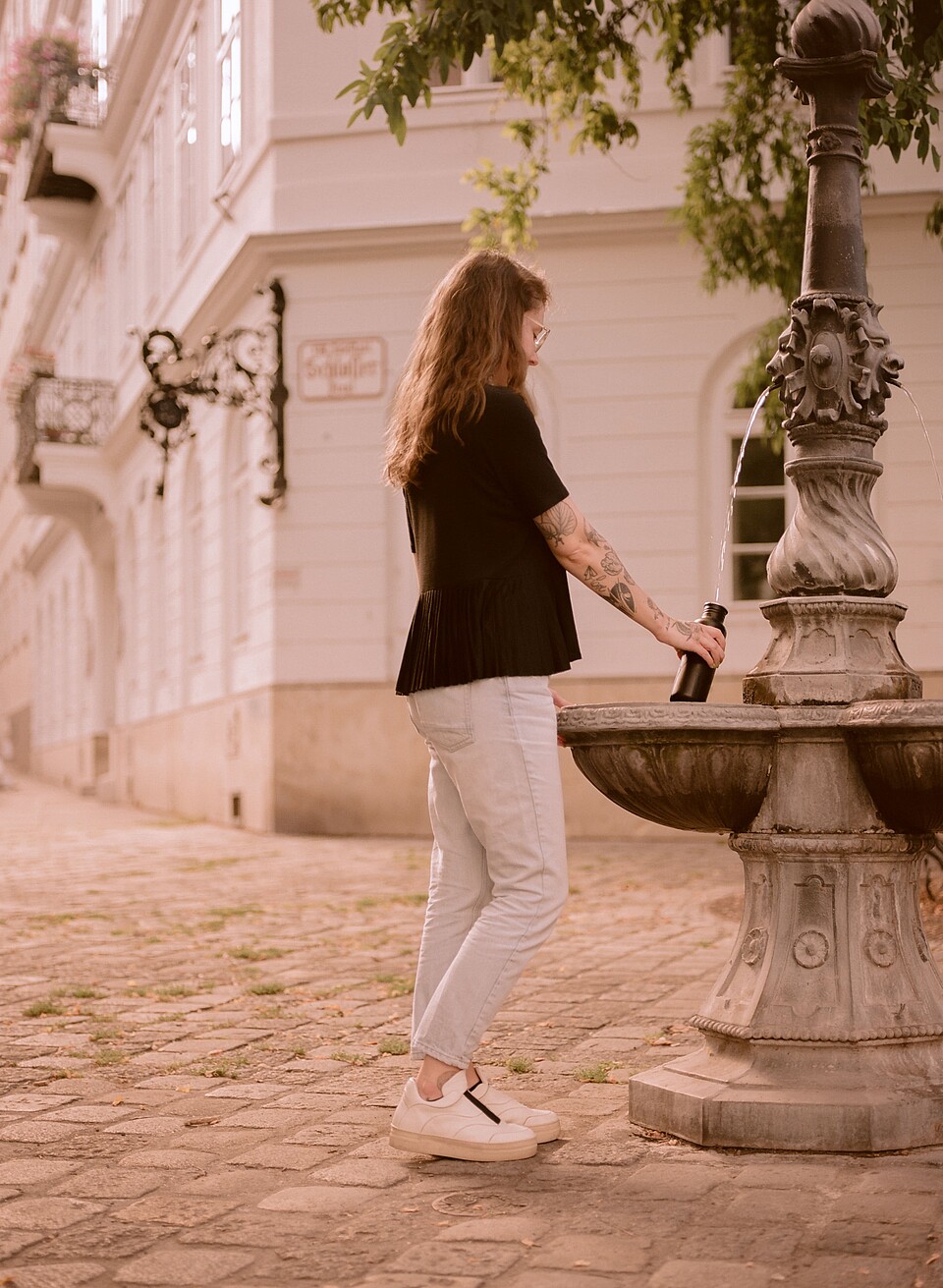 Vienna Water Supply Woman drinking at a water fountain in Vienna